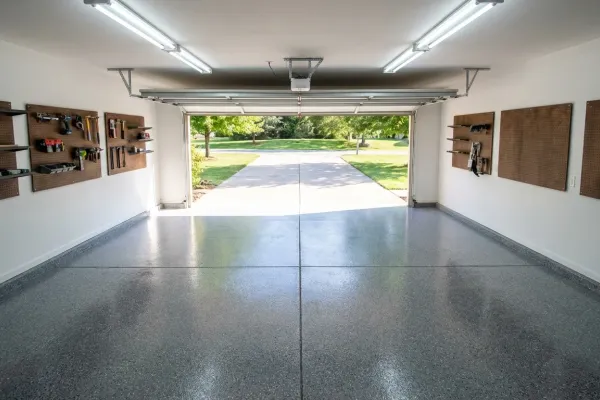 Residential garage floor with professional epoxy coating and decorative flake