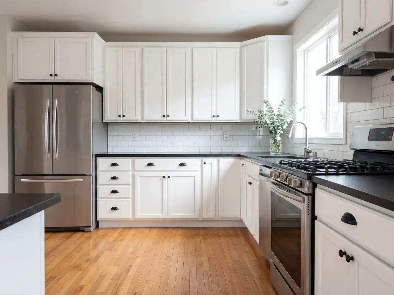 Oak kitchen cabinets transformed to crisp white spray finish